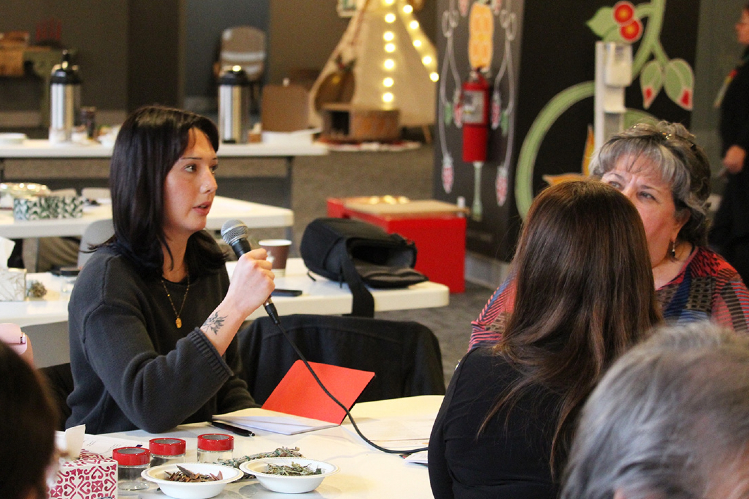 Harper Johnson speaks into a microphone at a Q&A session.
