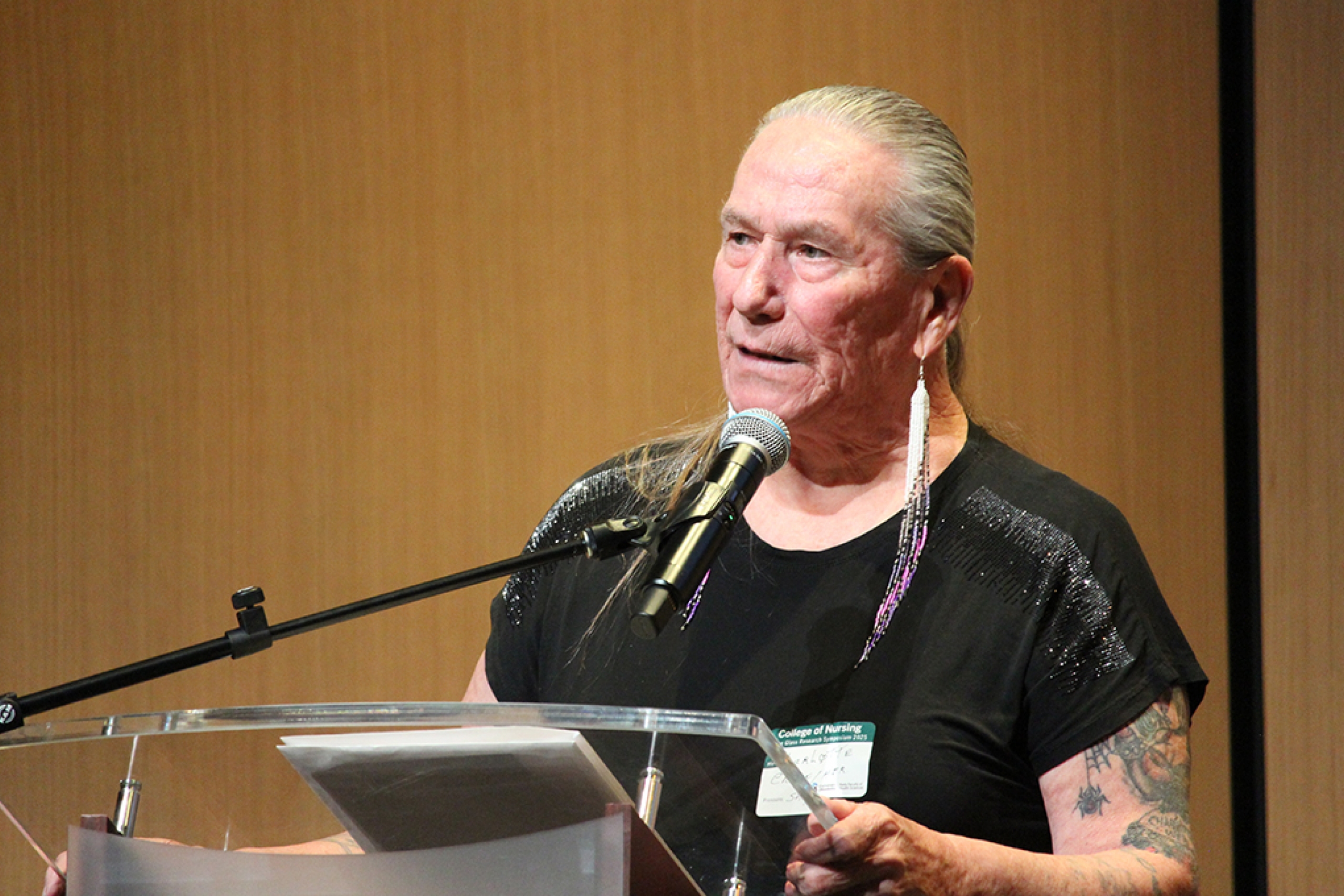 Charlotte Nolin speaks at a podium.