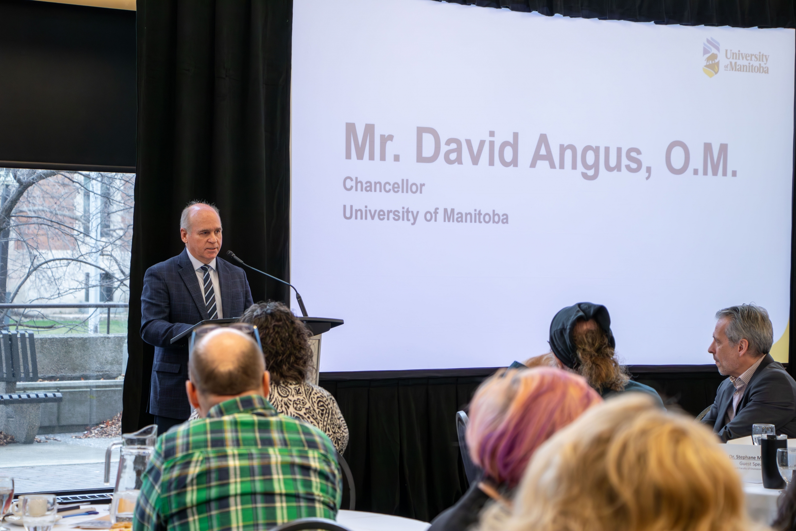 Mr. David Angus speaking on stage at the 2025 Faculty Symposium