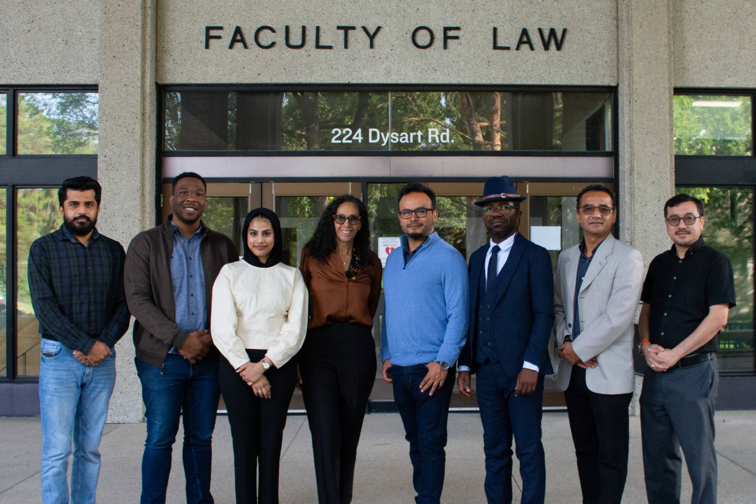 Internationally trained lawyers stand in front of Robson Hall