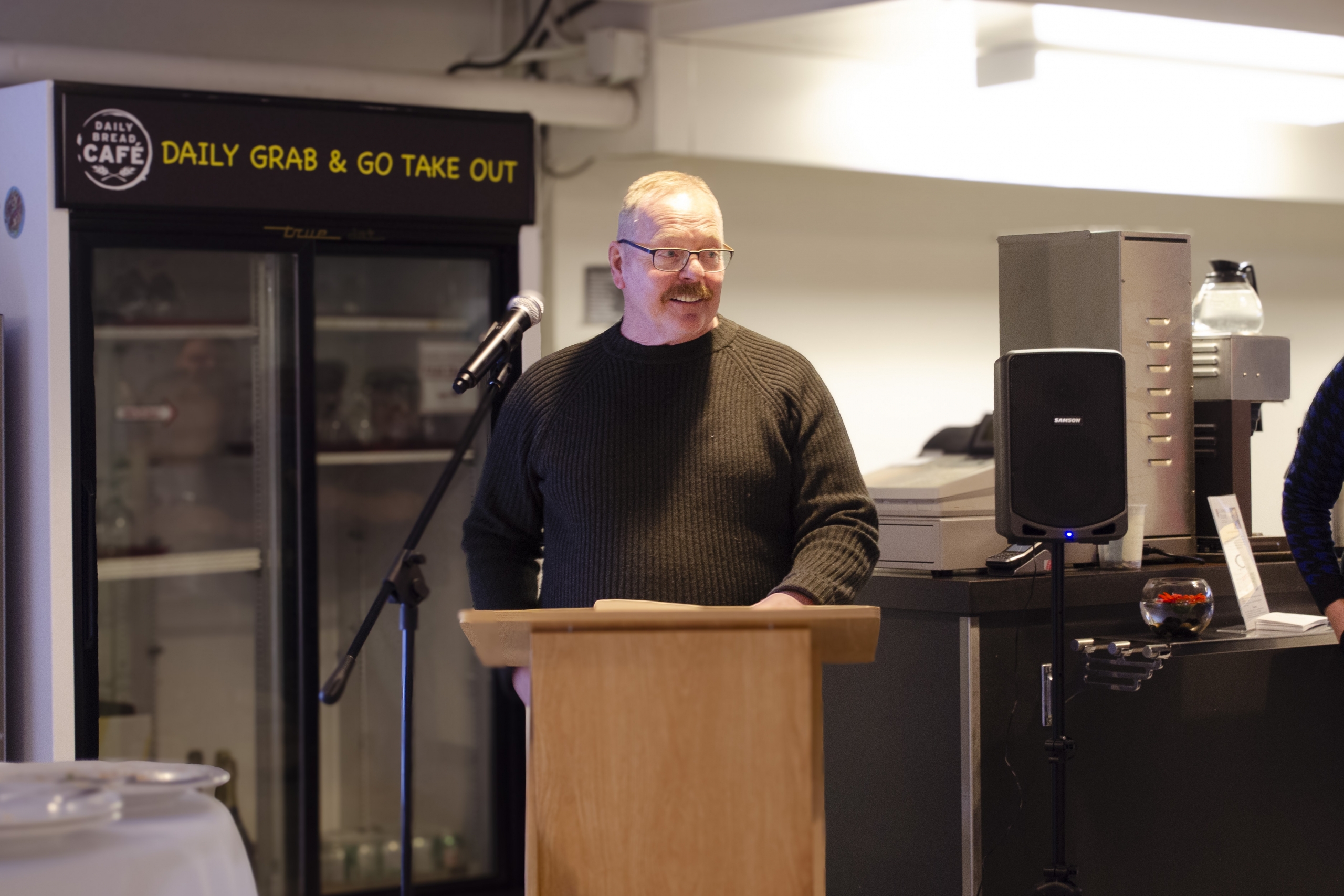 Ian Park standing in front of a podium and microphone