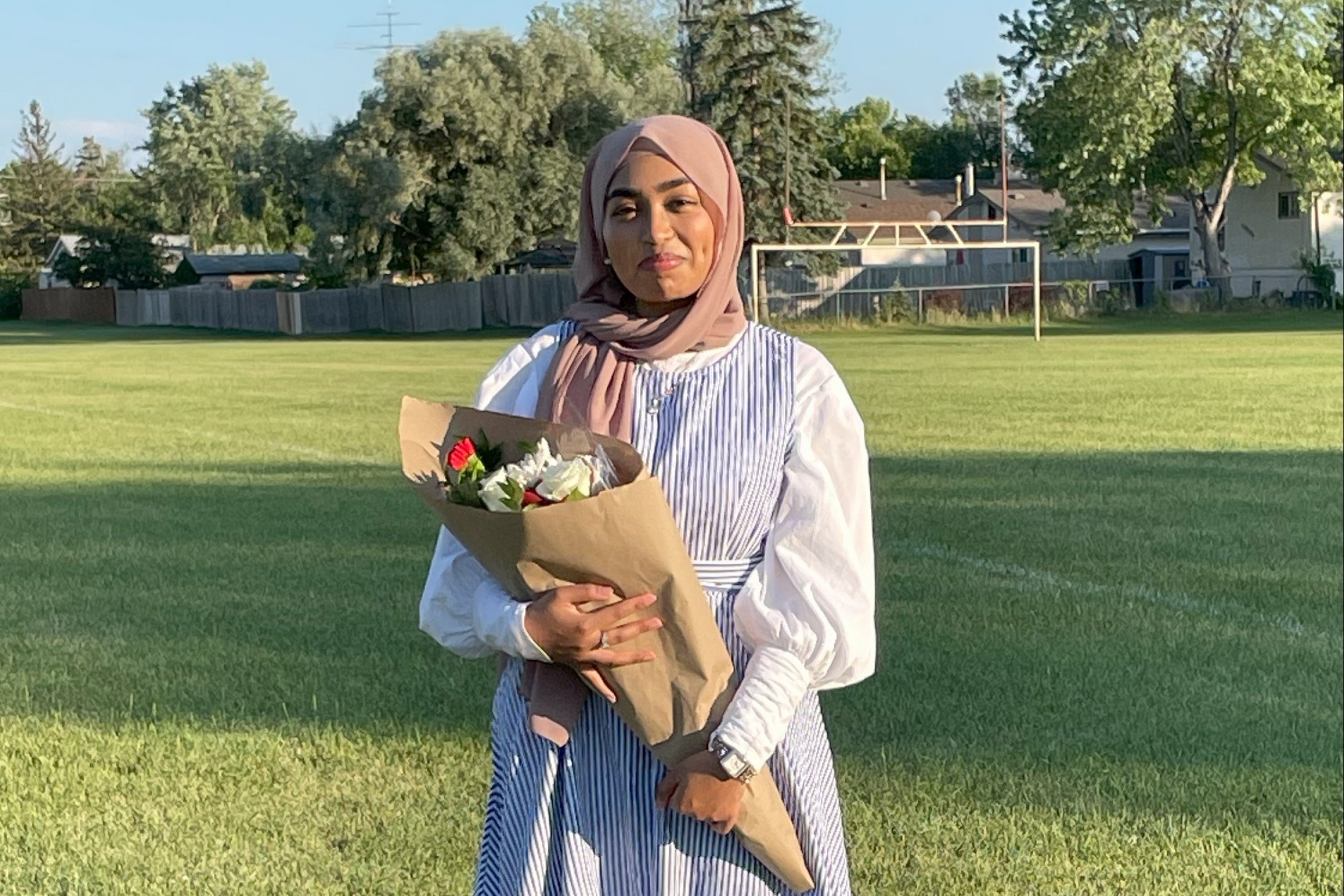 girl outside holding a bouquet of flowers