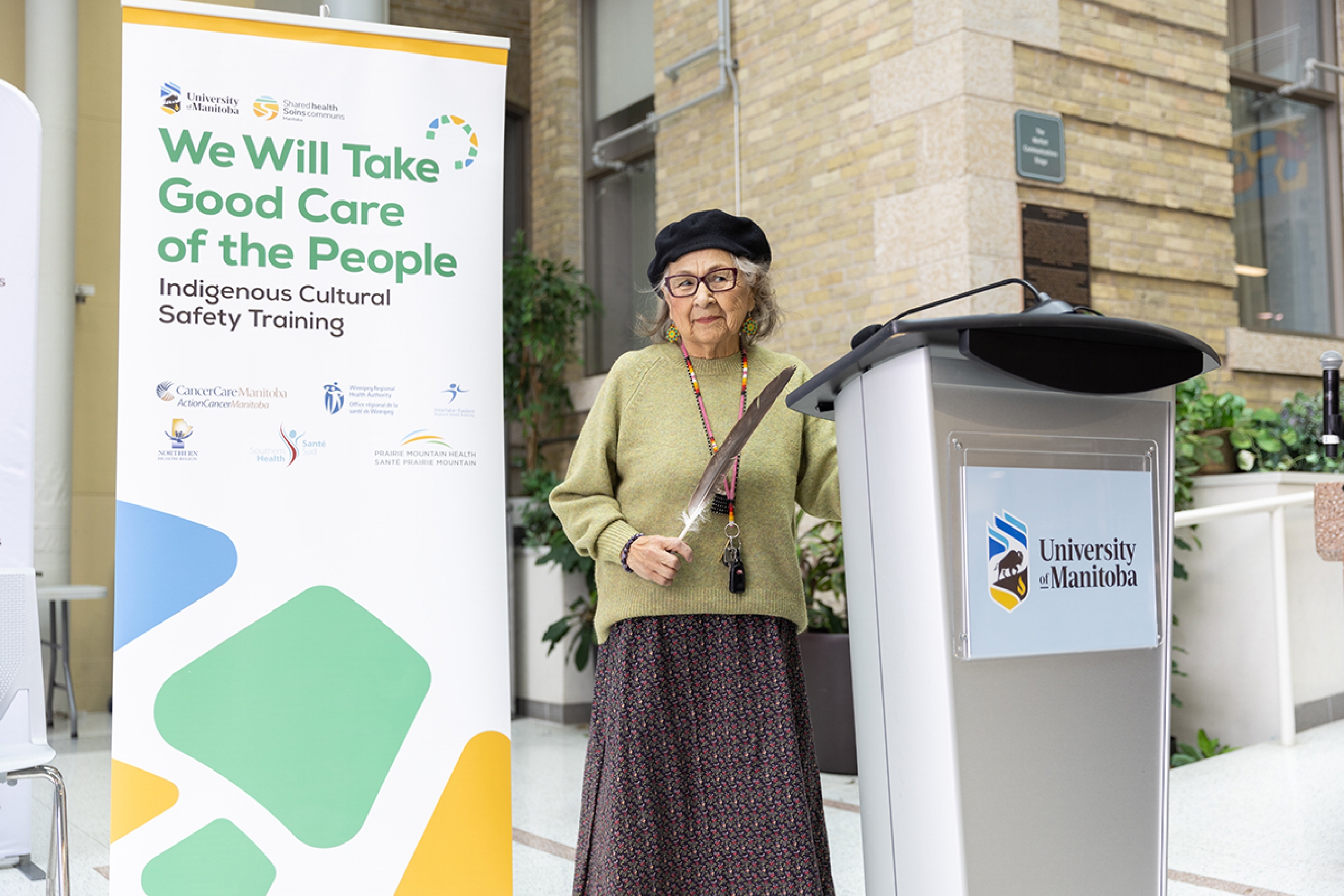 Elder Margaret Lavallee stands at a podium.