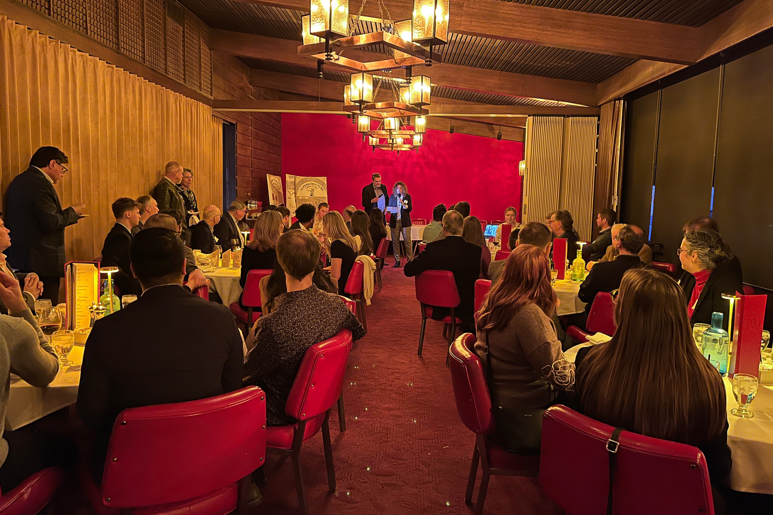 Two speakers presenting in a restaurant 
