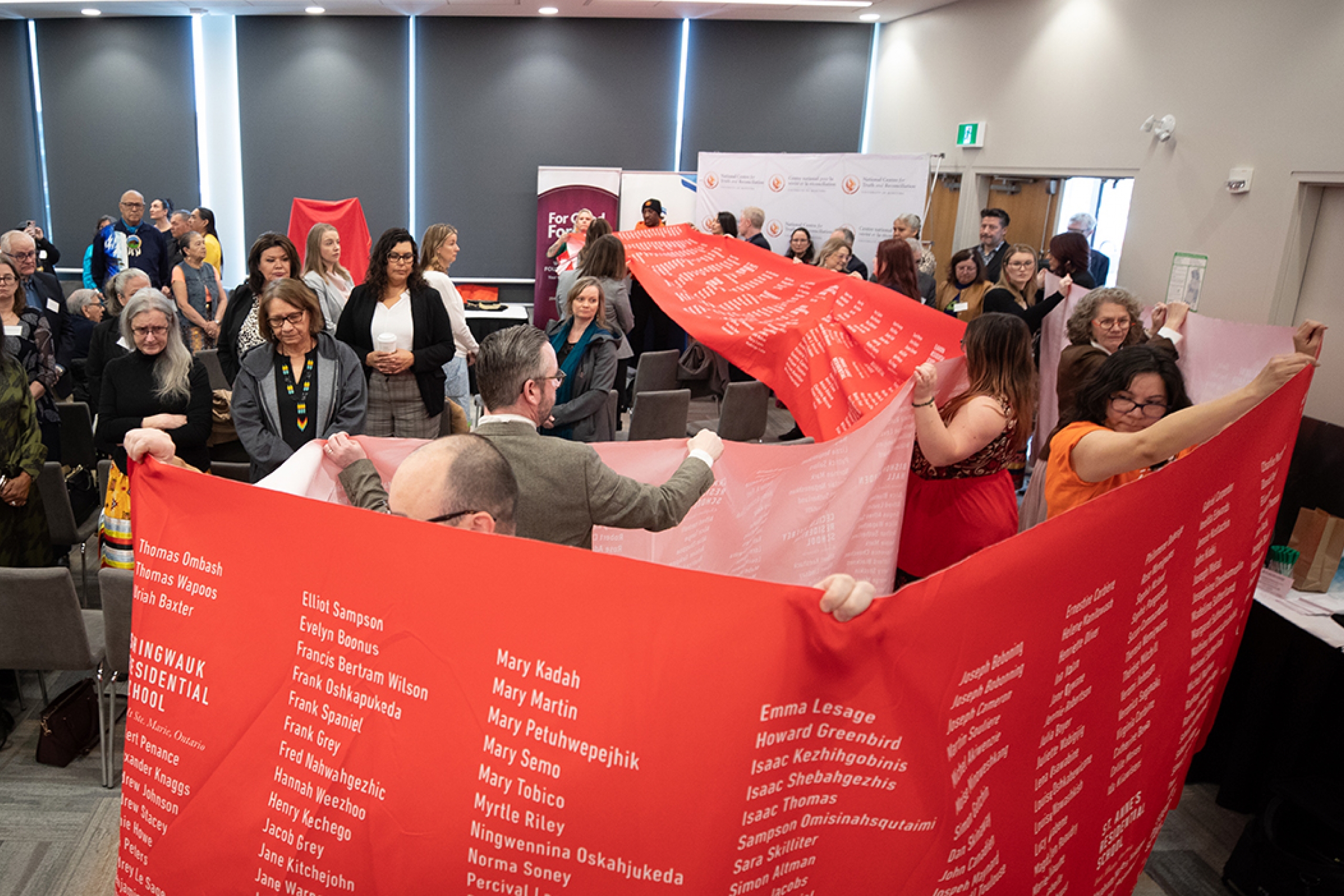 The Memorial Cloth being carried into a room