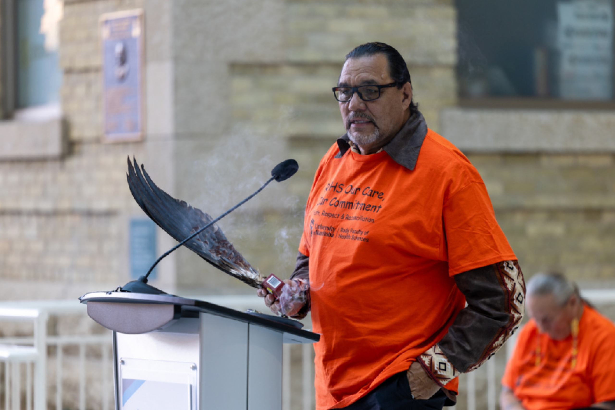 George Muswaggon, Knowledge Keeper at Ongomiizwin, shared teachings onstage.