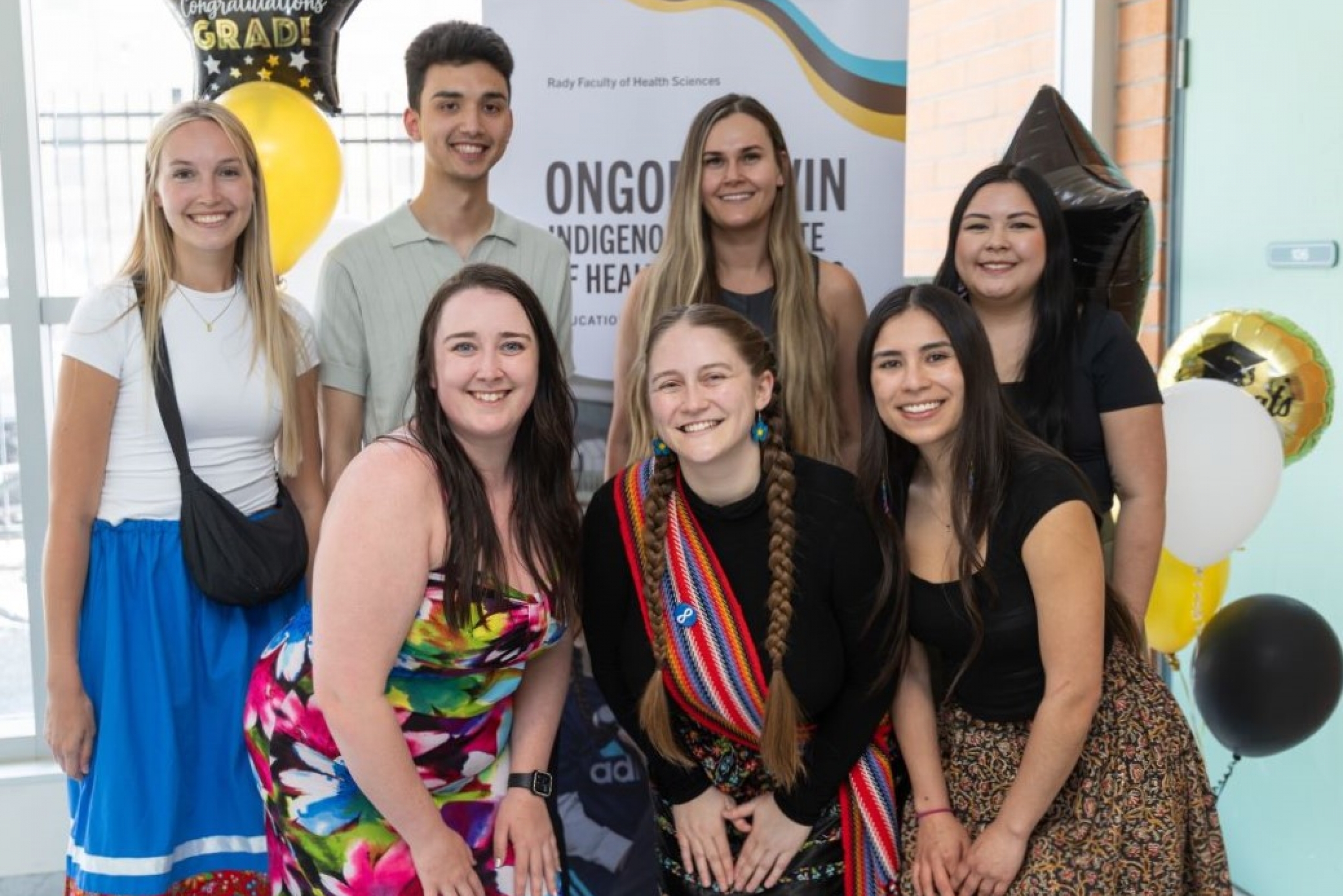 Seven Indigenous graduates of the Rady Faculty pose at their graduation celebration.