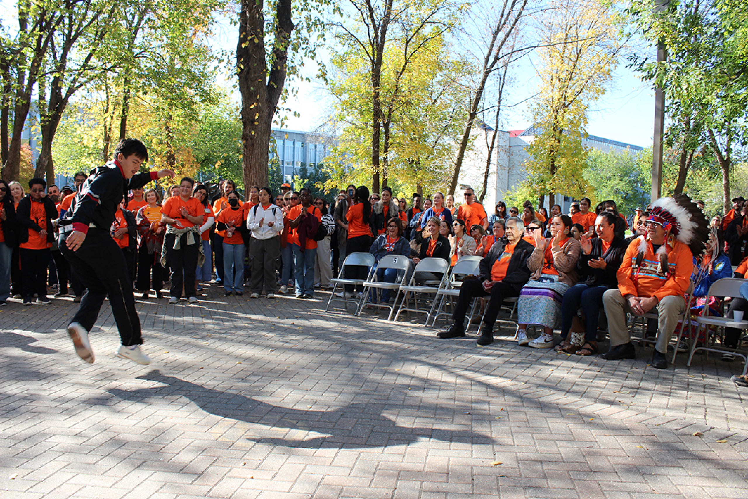 Jordan Flett, a student from Norway House Cree Nation, performs a cultural dance as part of the Orange Shirt Day ceremony outside the Helen Glass Centre for Nursing.