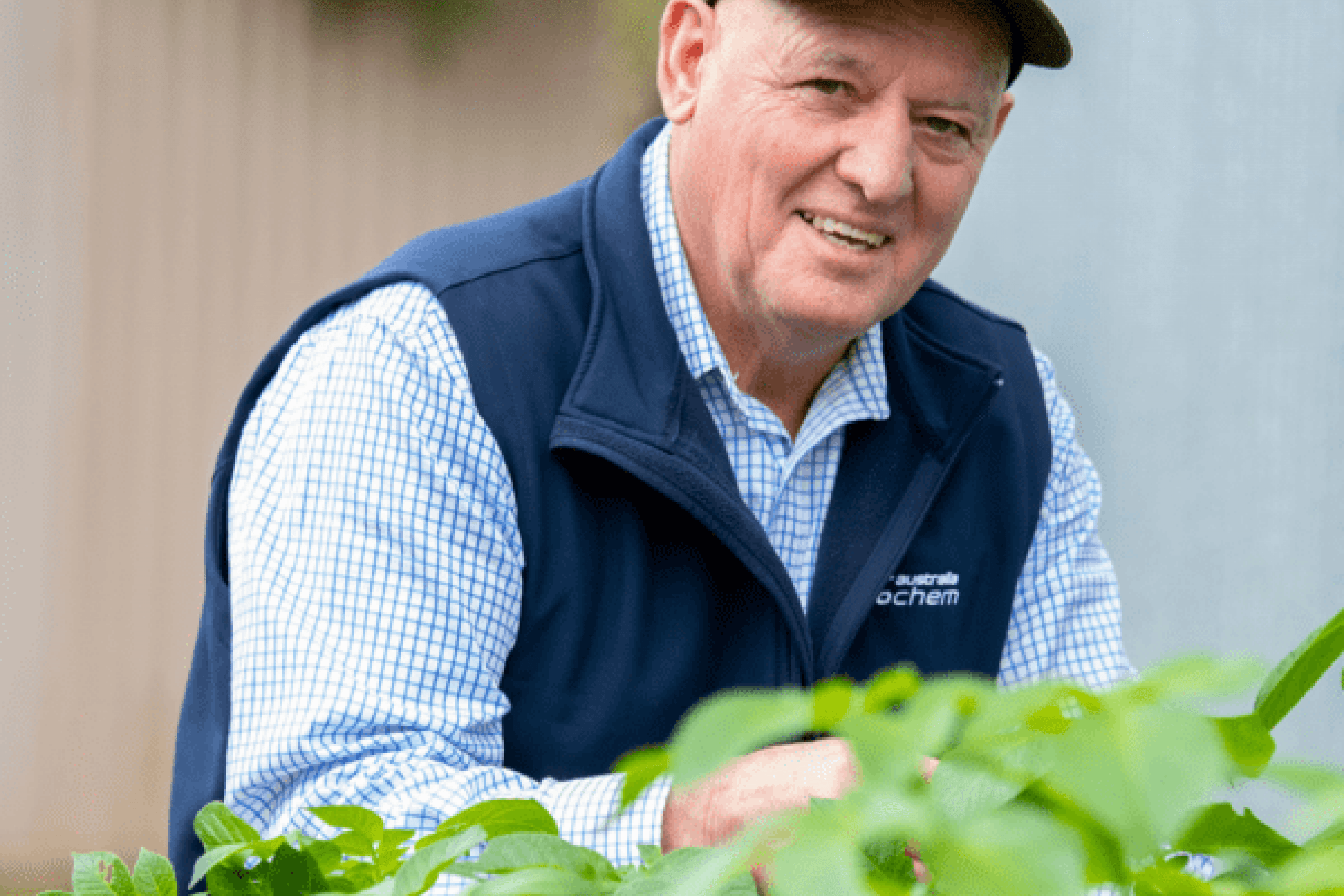 A man looking at the camera with bushes in the foreground