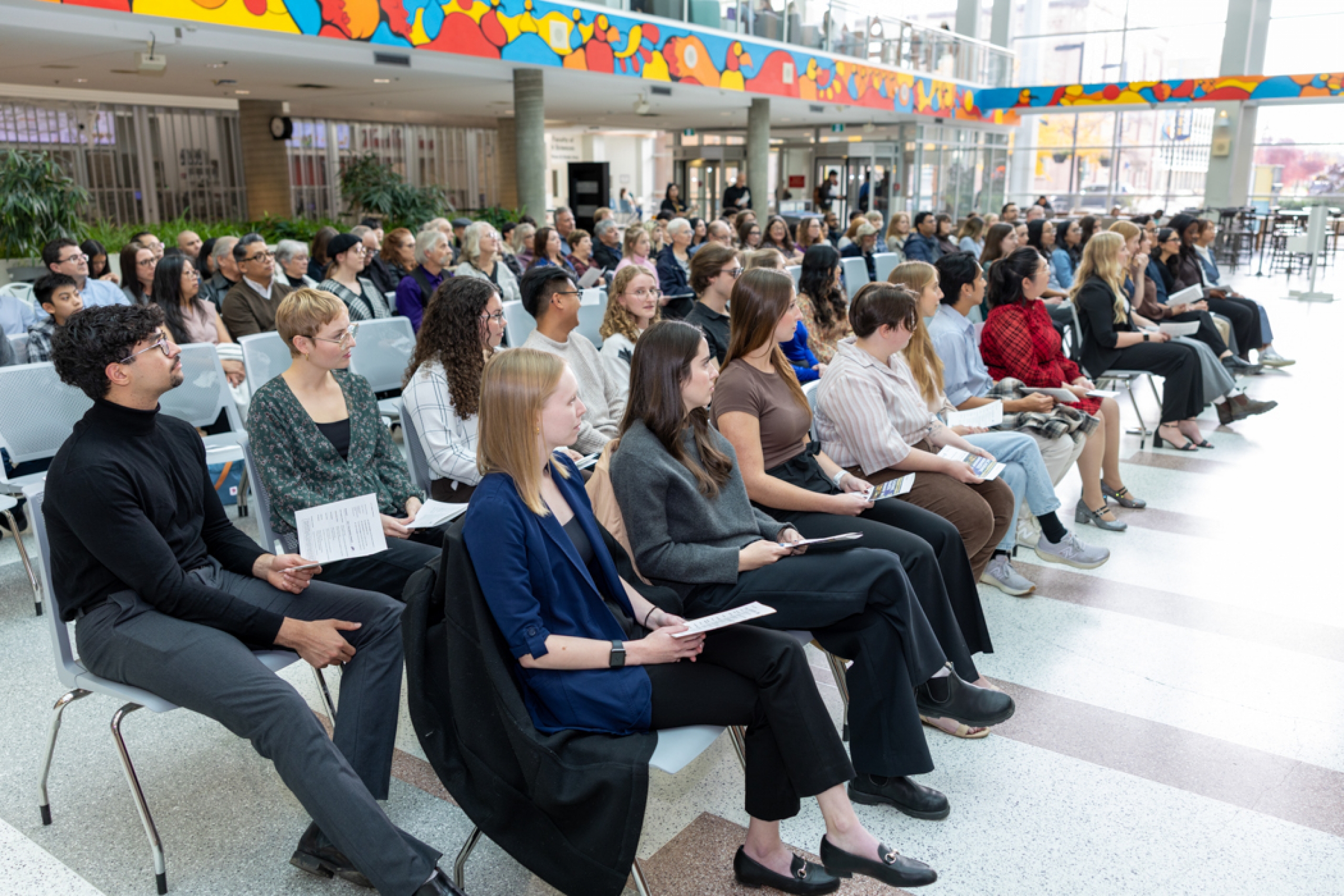 Students sitting by the Brodie Atrium.