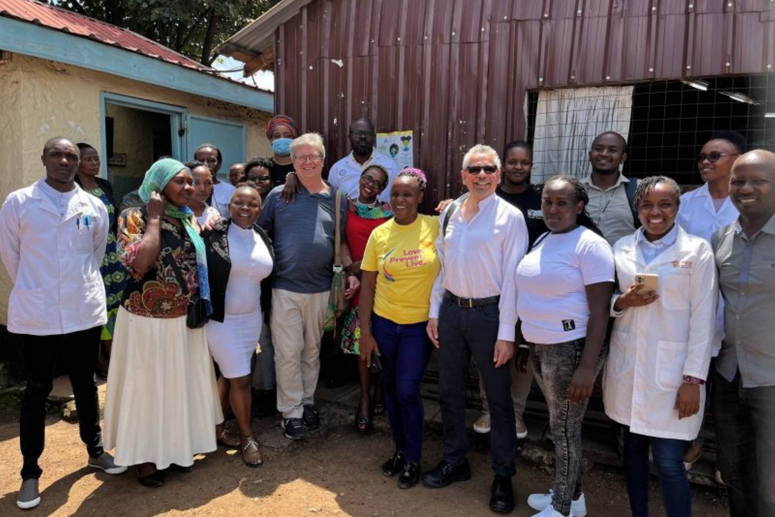 Dr. Keith Fowke and Dr. Mario Pinto with patient cohort at Nairobi research clinic.