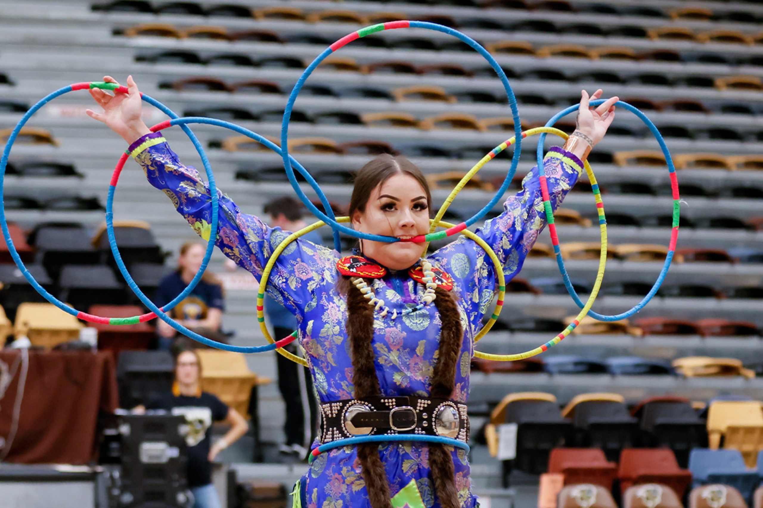An Indigenous dancer performing with hoops