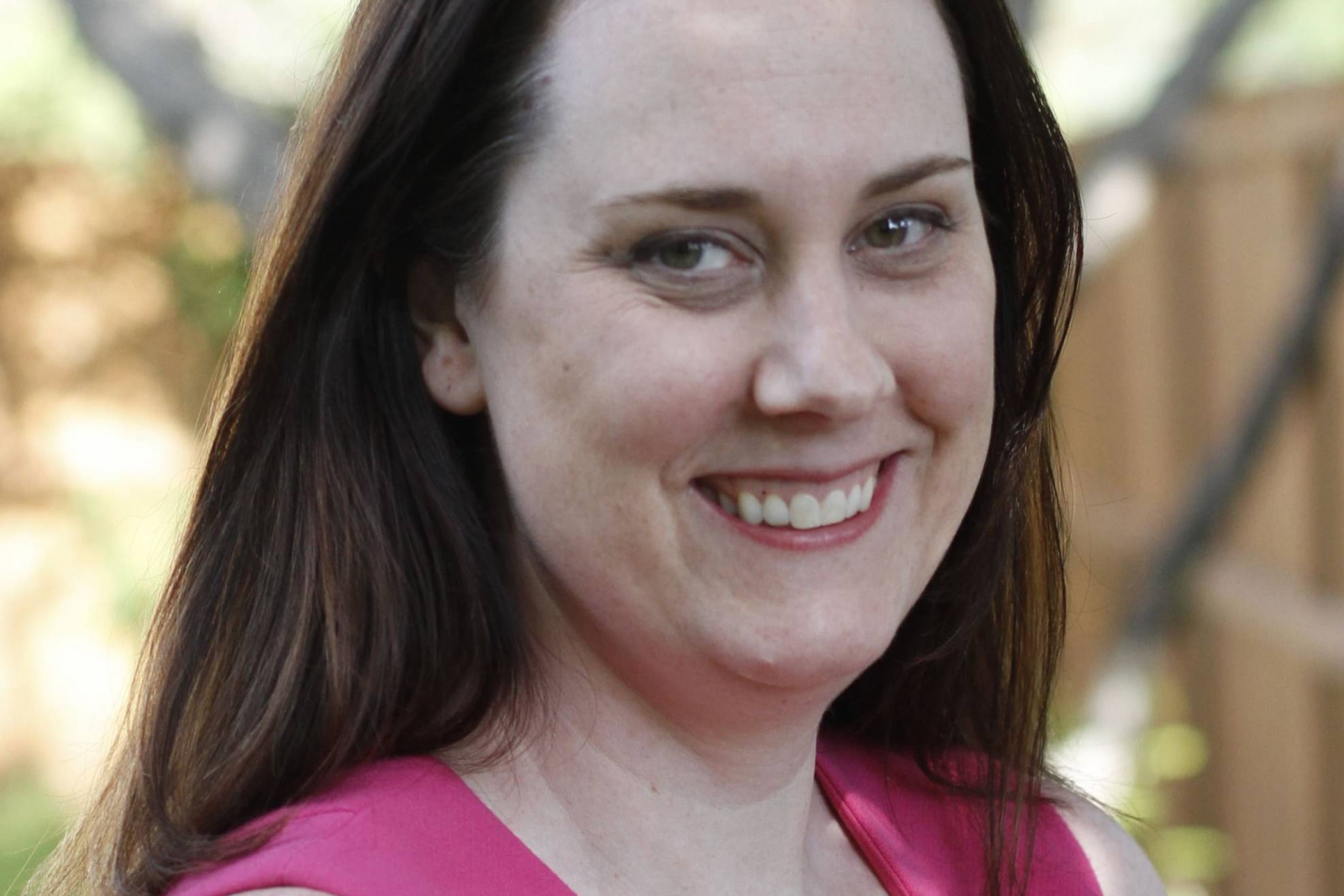 Smiling brunette woman in pink