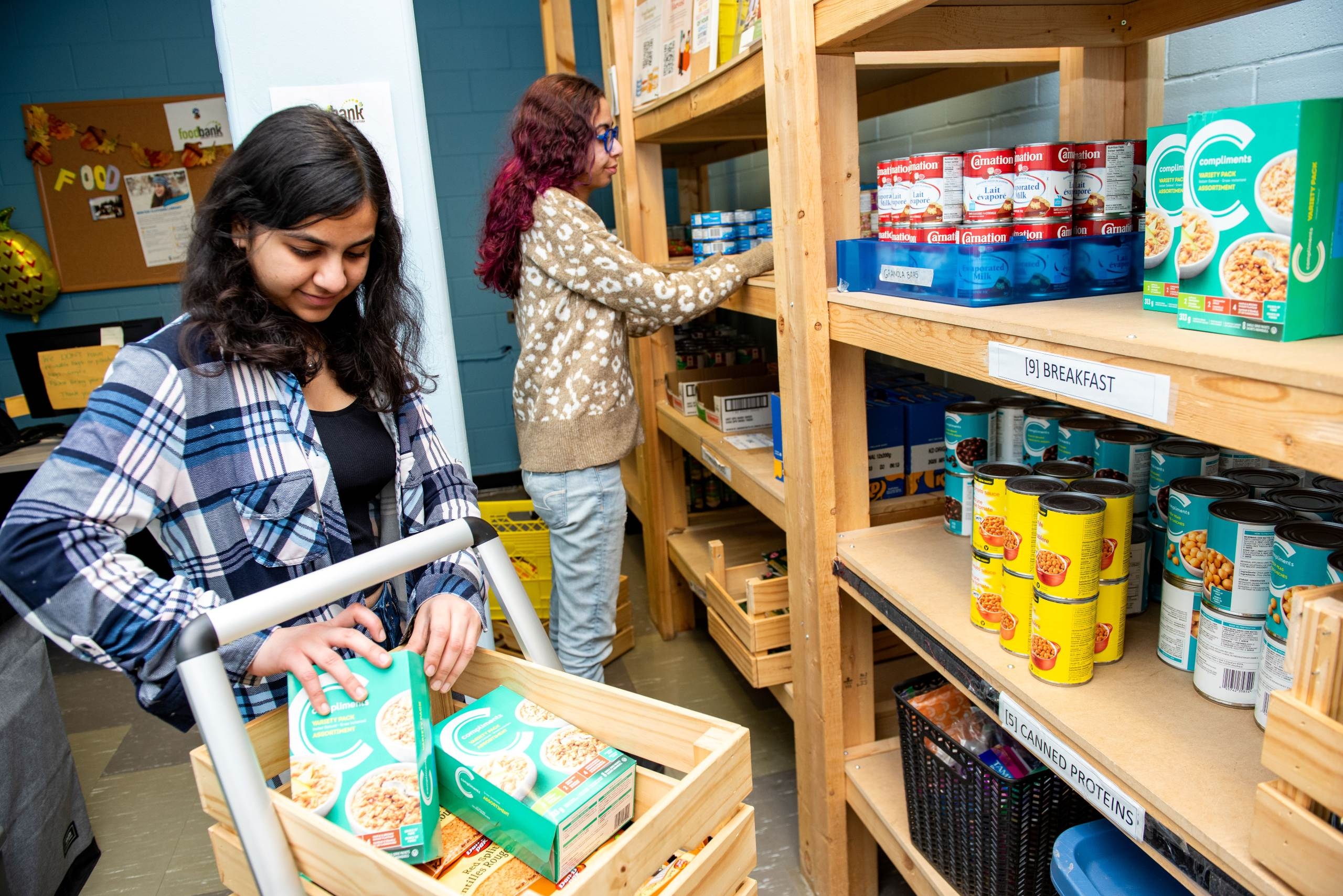 Two students in the campus food bank.