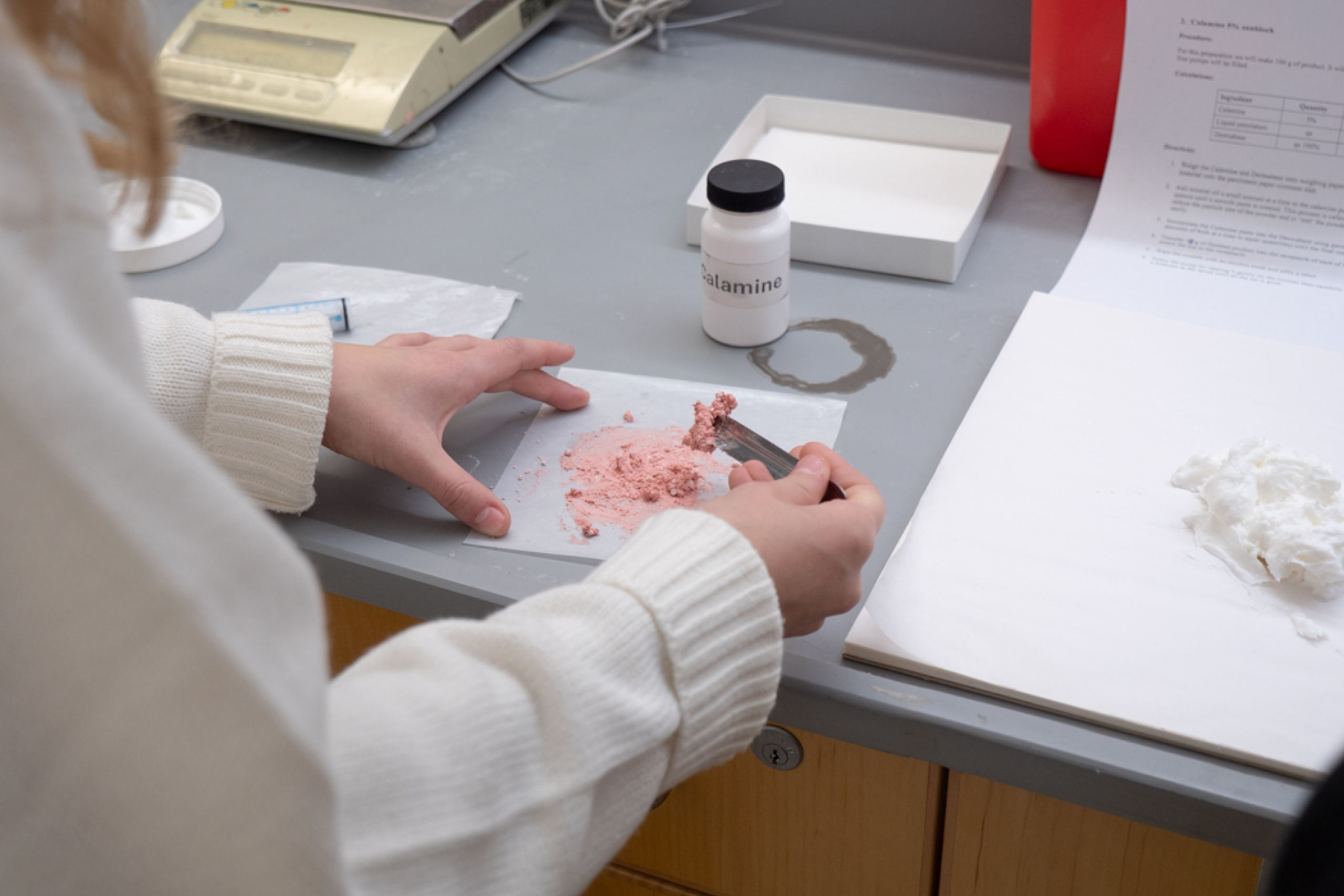 Close-up of a student’s hand performing a hands-on exercise at the College of Pharmacy.