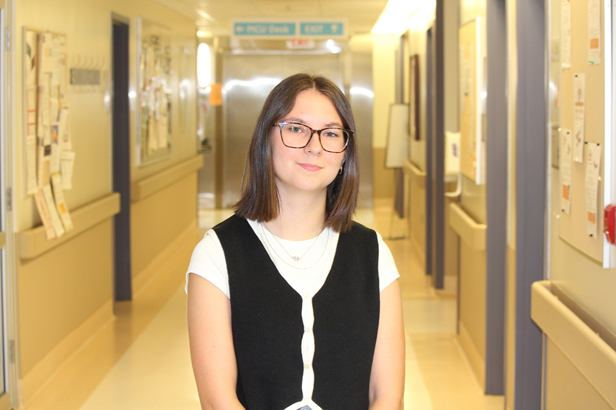 Taylor Davidson standing in a hospital hallway.