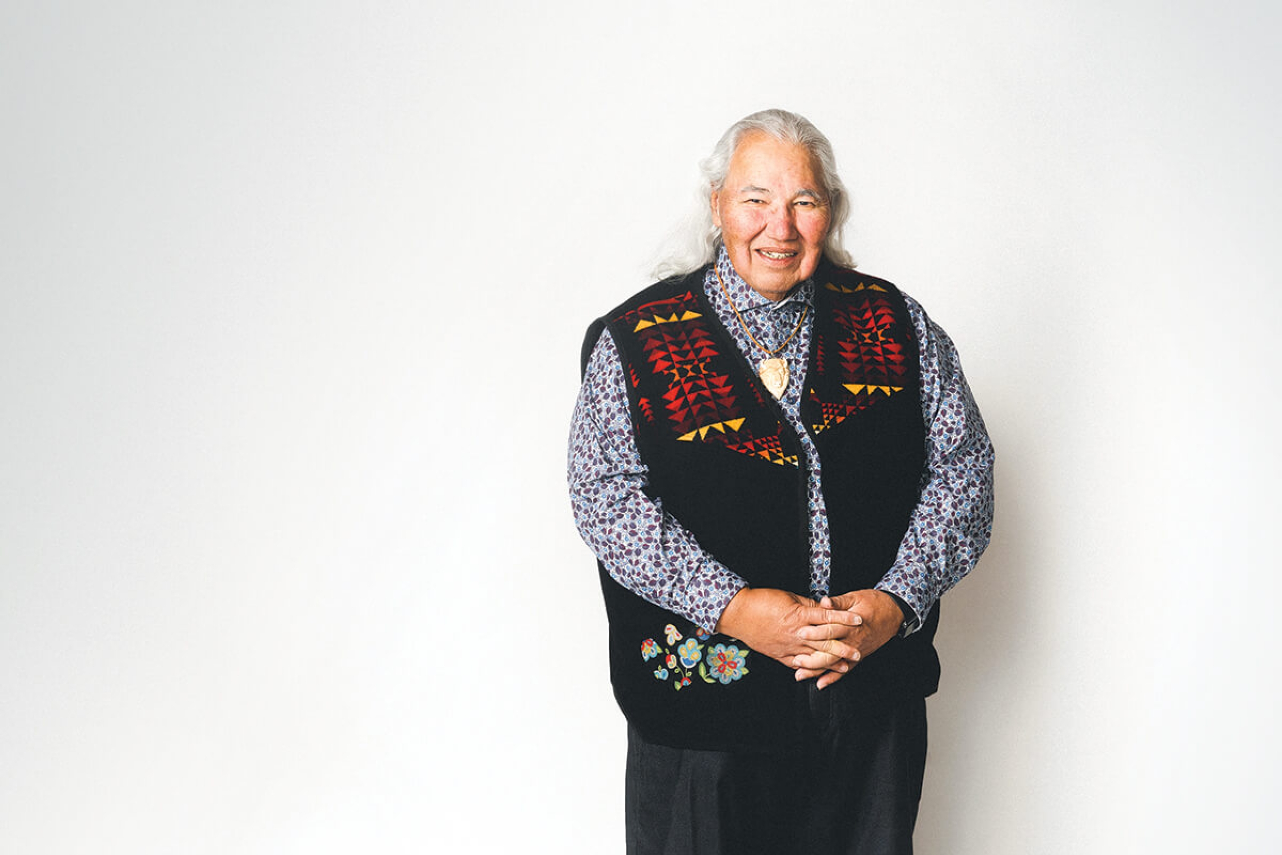 Murray Sinclair poses against a white wall.