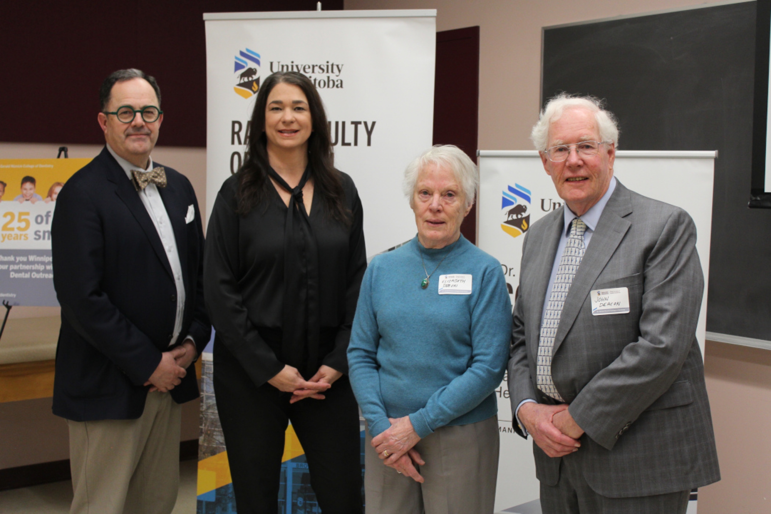 Four people pose for the photo.