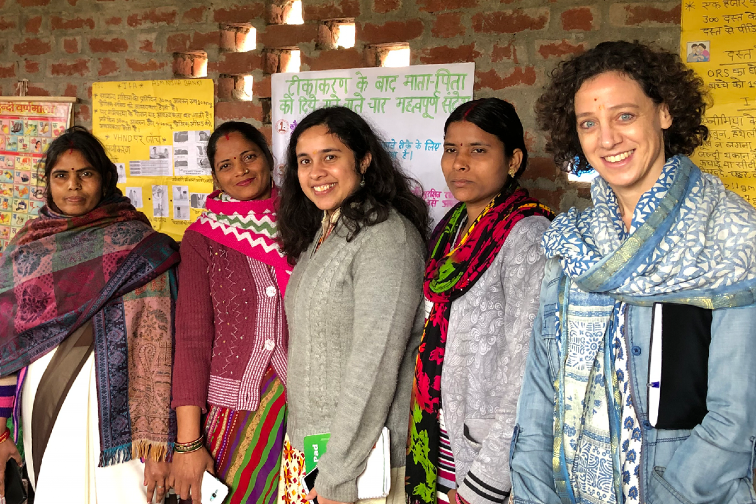 A group of five people smiling at the camera.