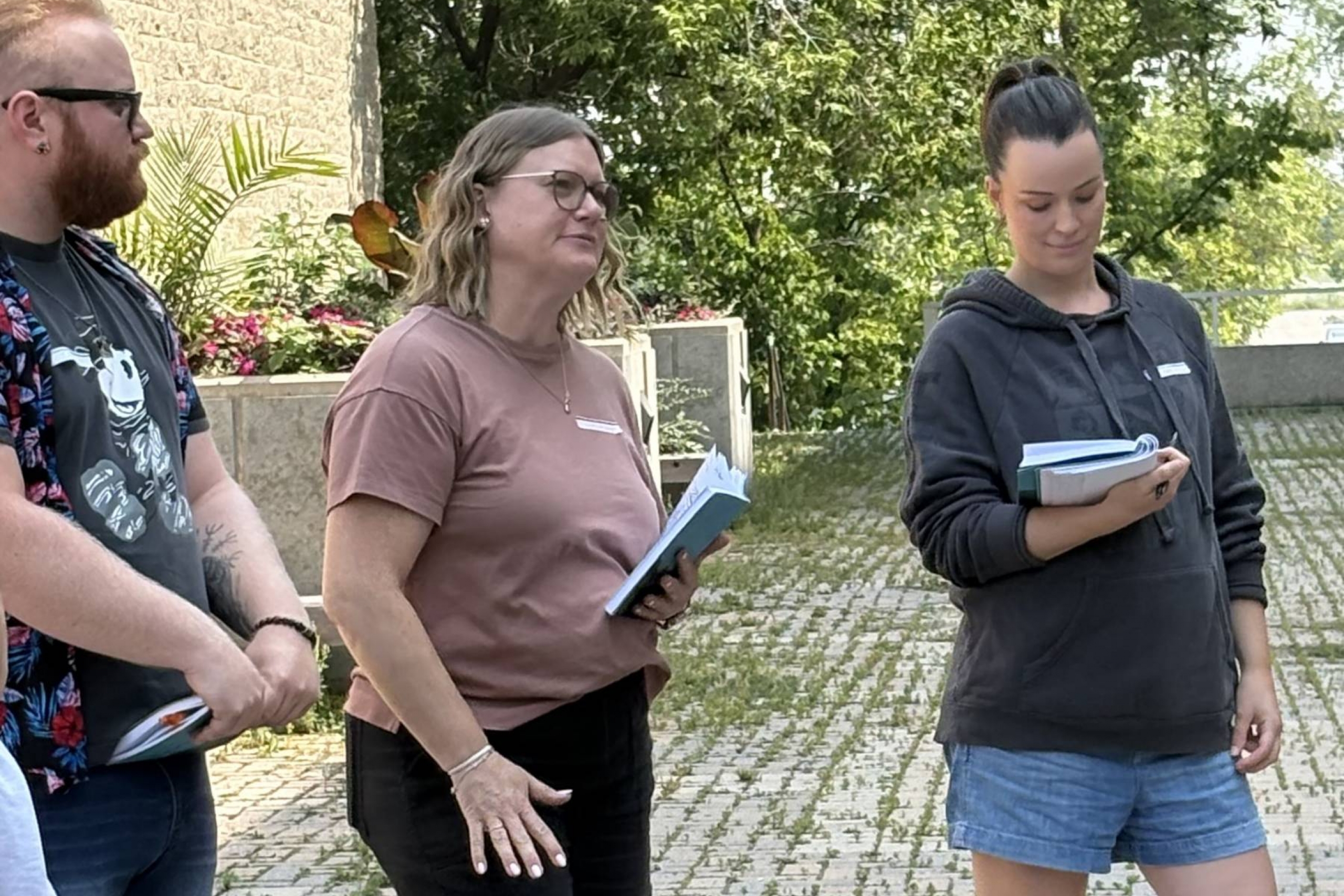 Three students standing outside.