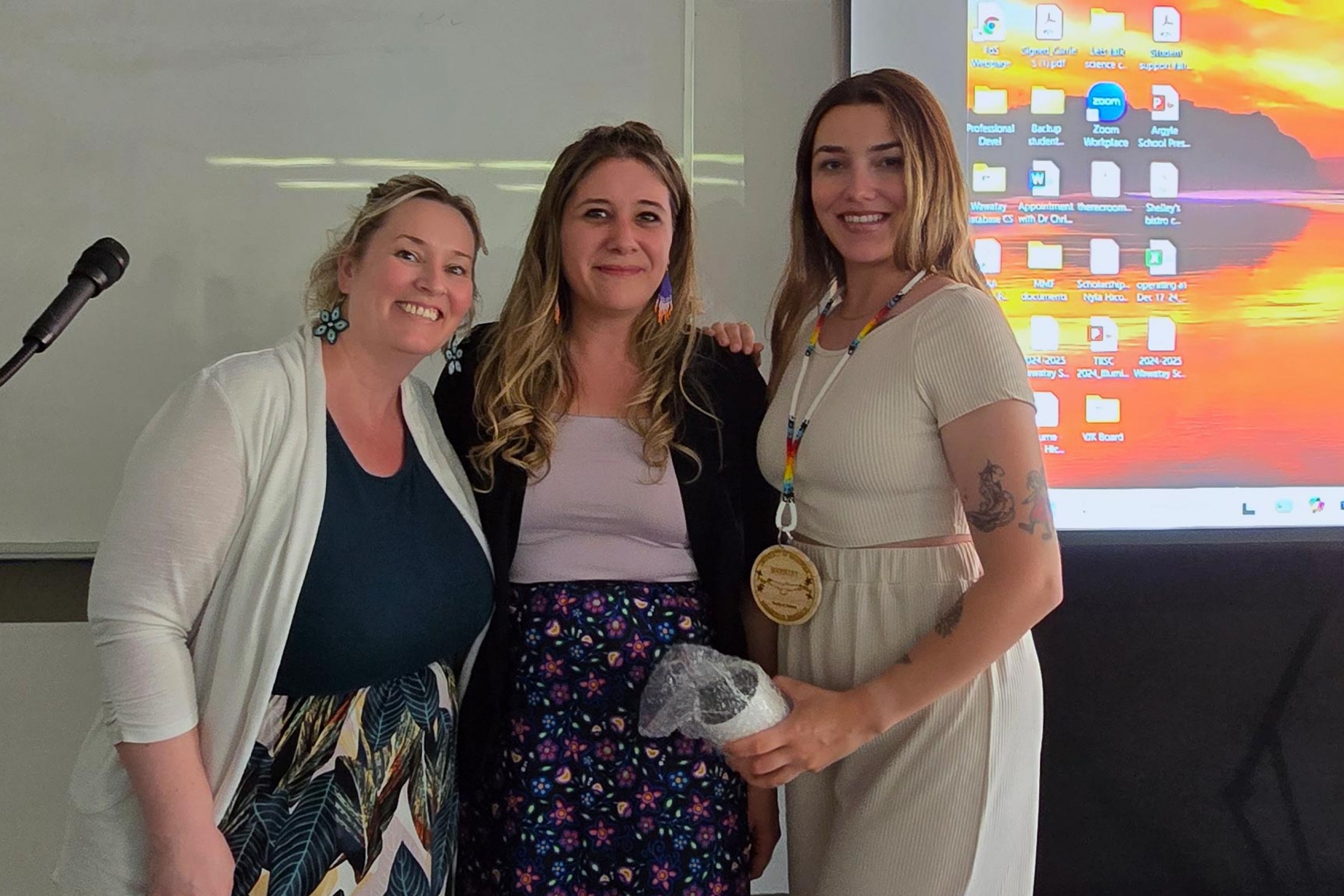 Carrie Selin, Melanie Lalonde and Taylor Macleod smiling at the camera.