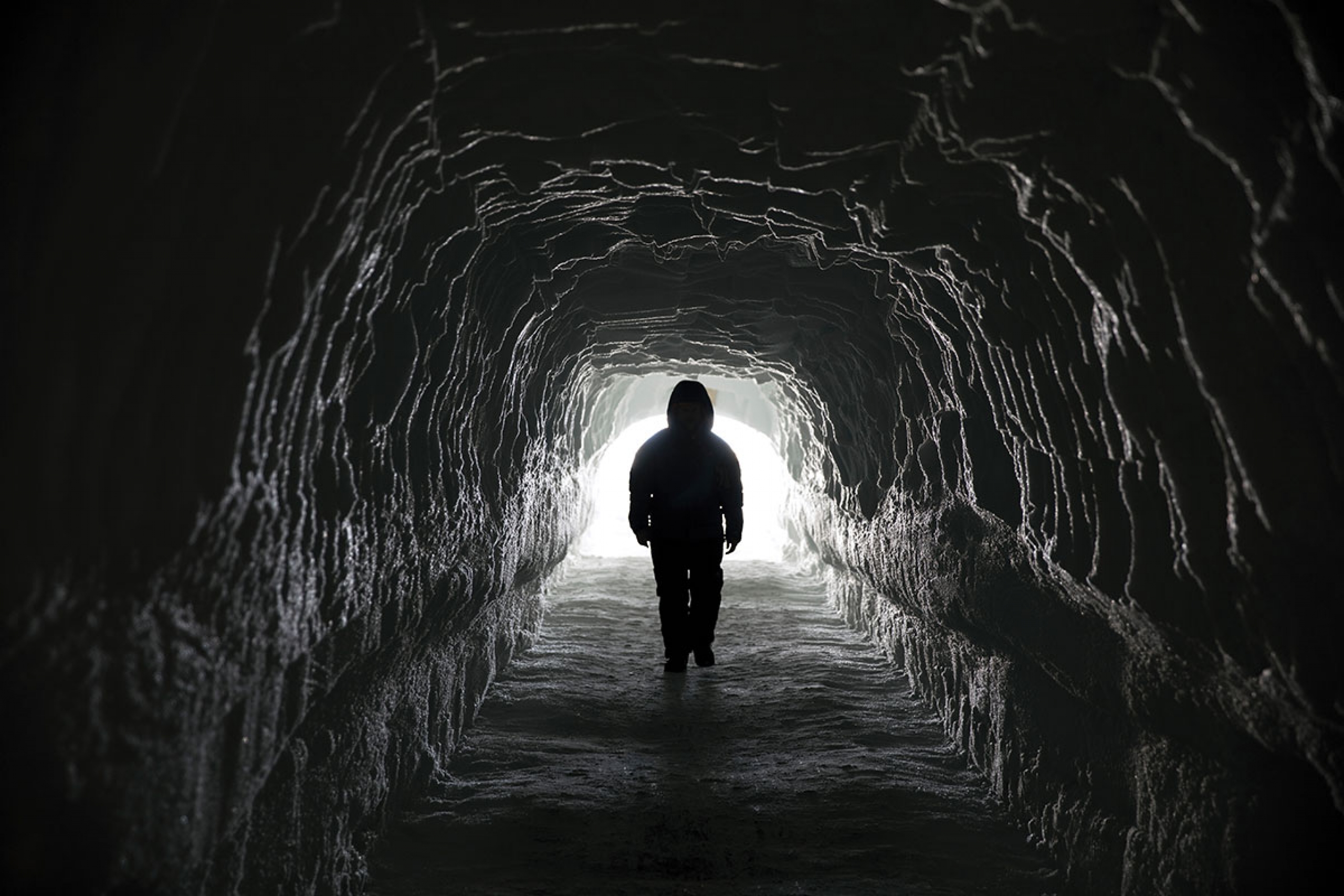 A man walking down a tunnel