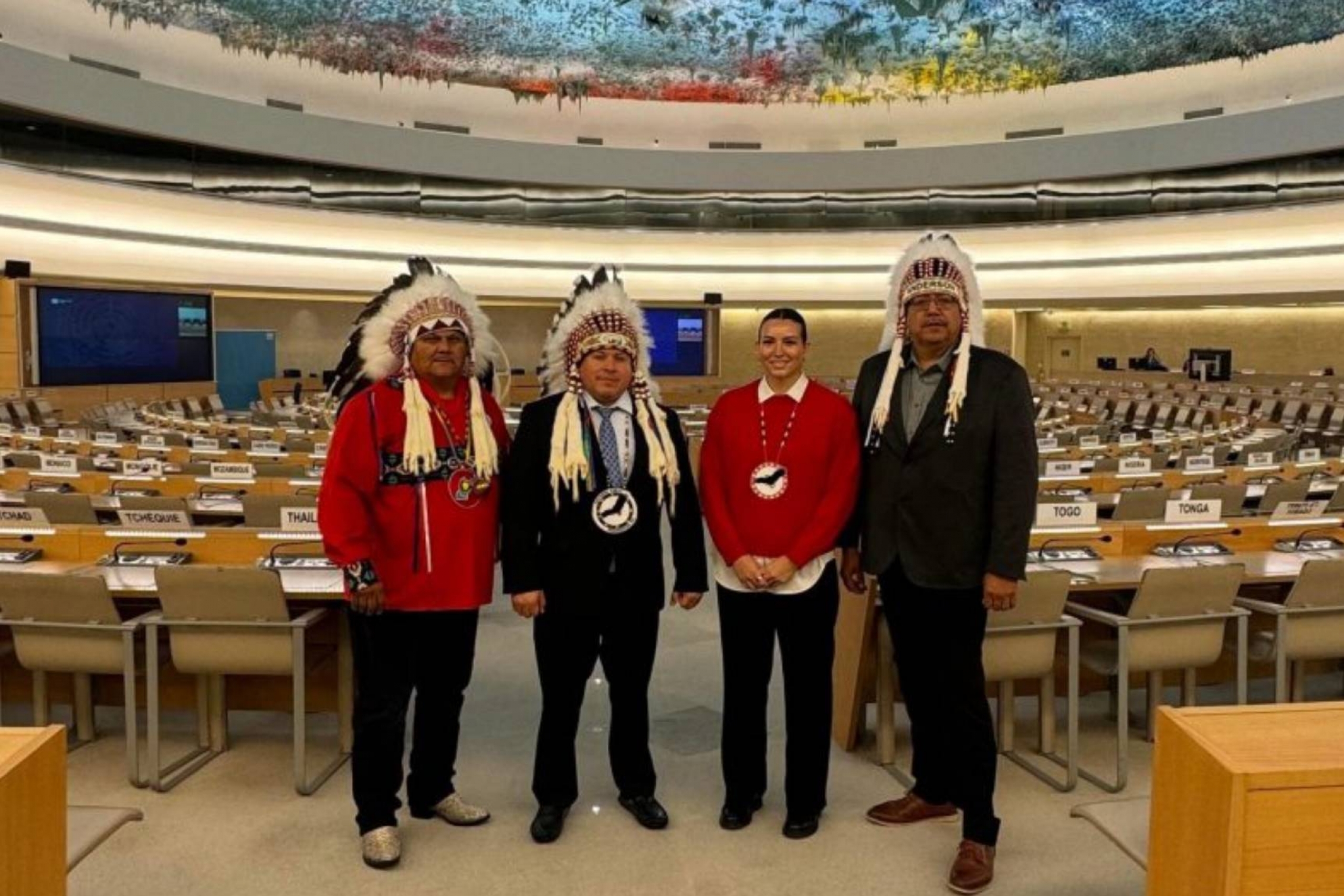 Four people posing for a photo together.