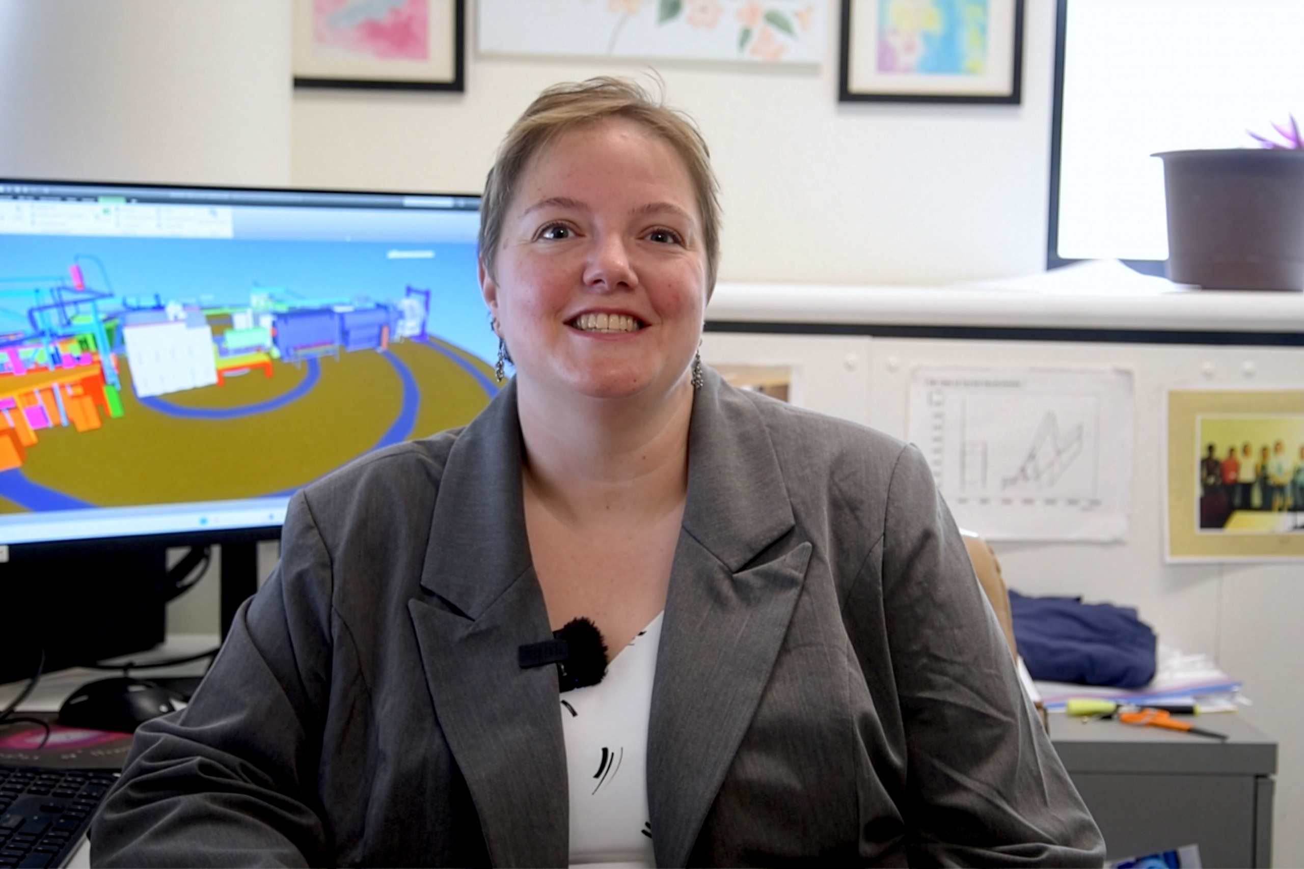 Dr. Juliette Mammei wearing a gray coat and smiling at the camera.