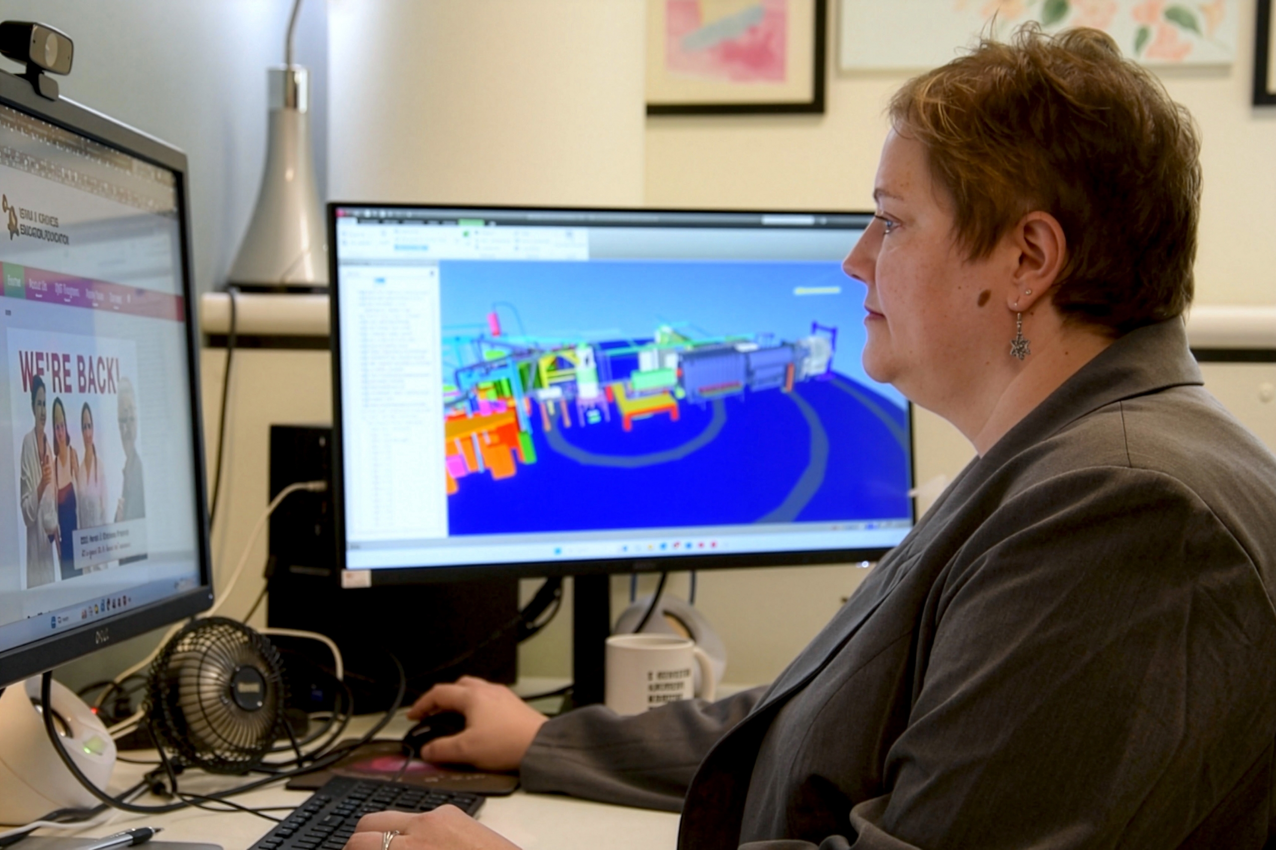 Dr. Juliette Mammei wearing a gray coat and working on the computer.