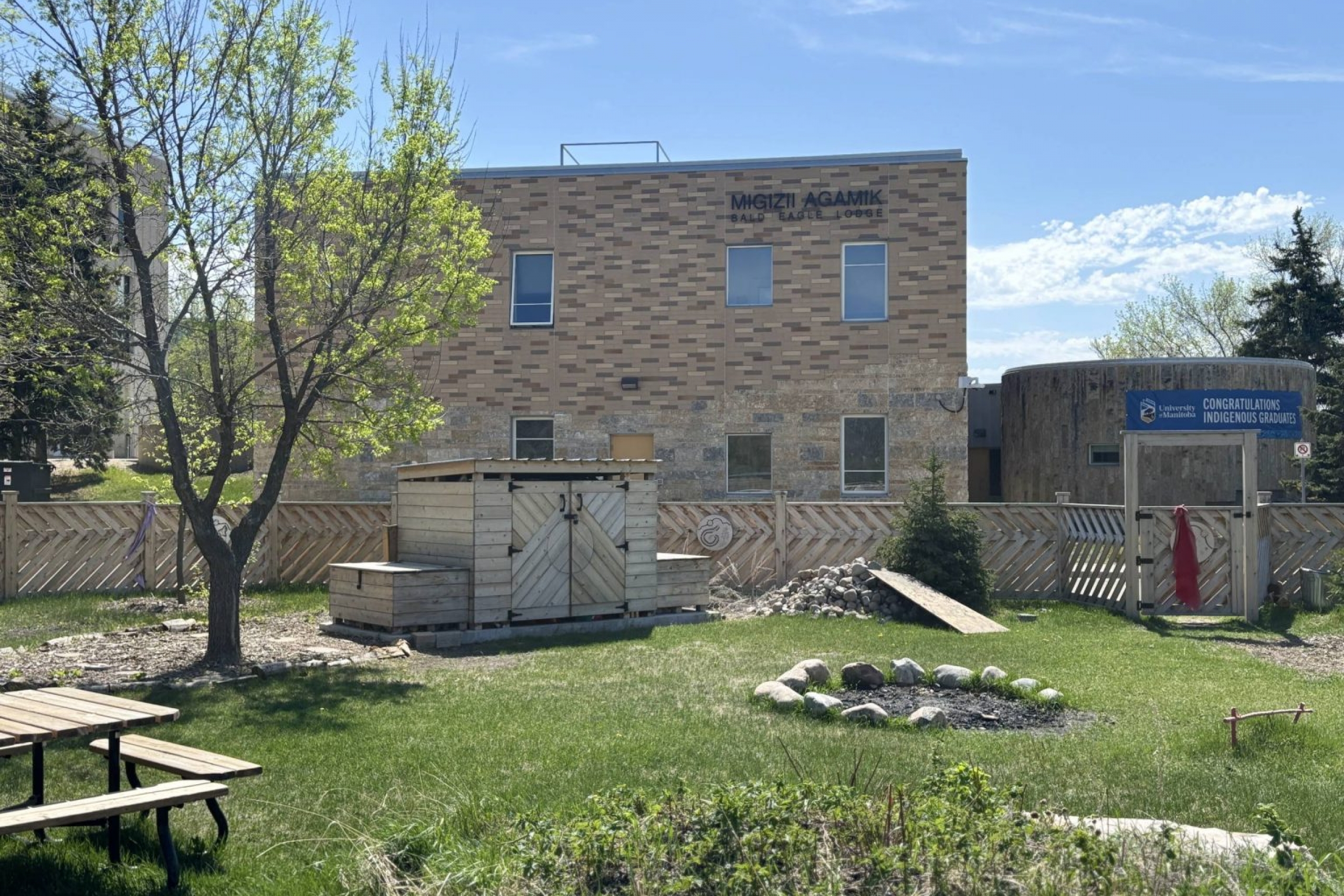 Exterior of a building showing a smaller wooden structre in an outdoor space
