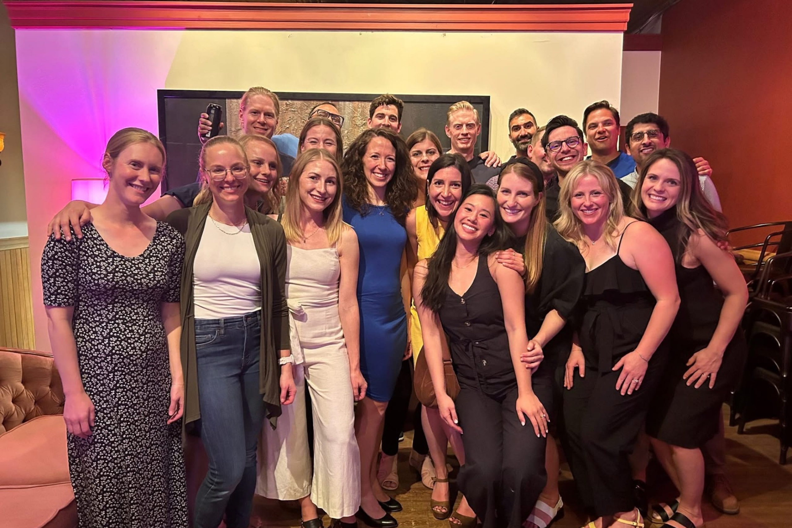 a group of university alumni gather and pose for a photo