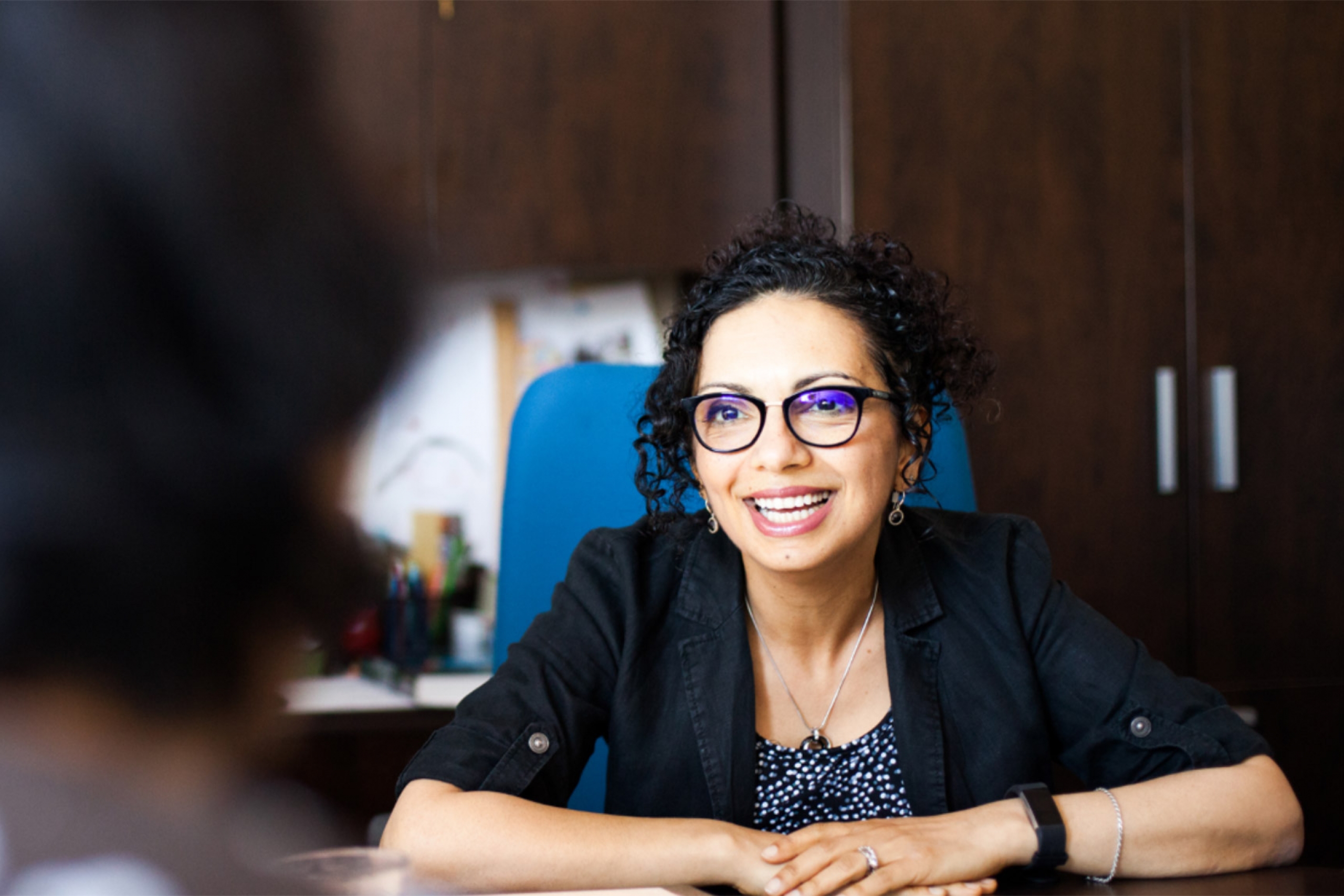 Samar Safi-Harb wearing a black coat and an eyeglass.