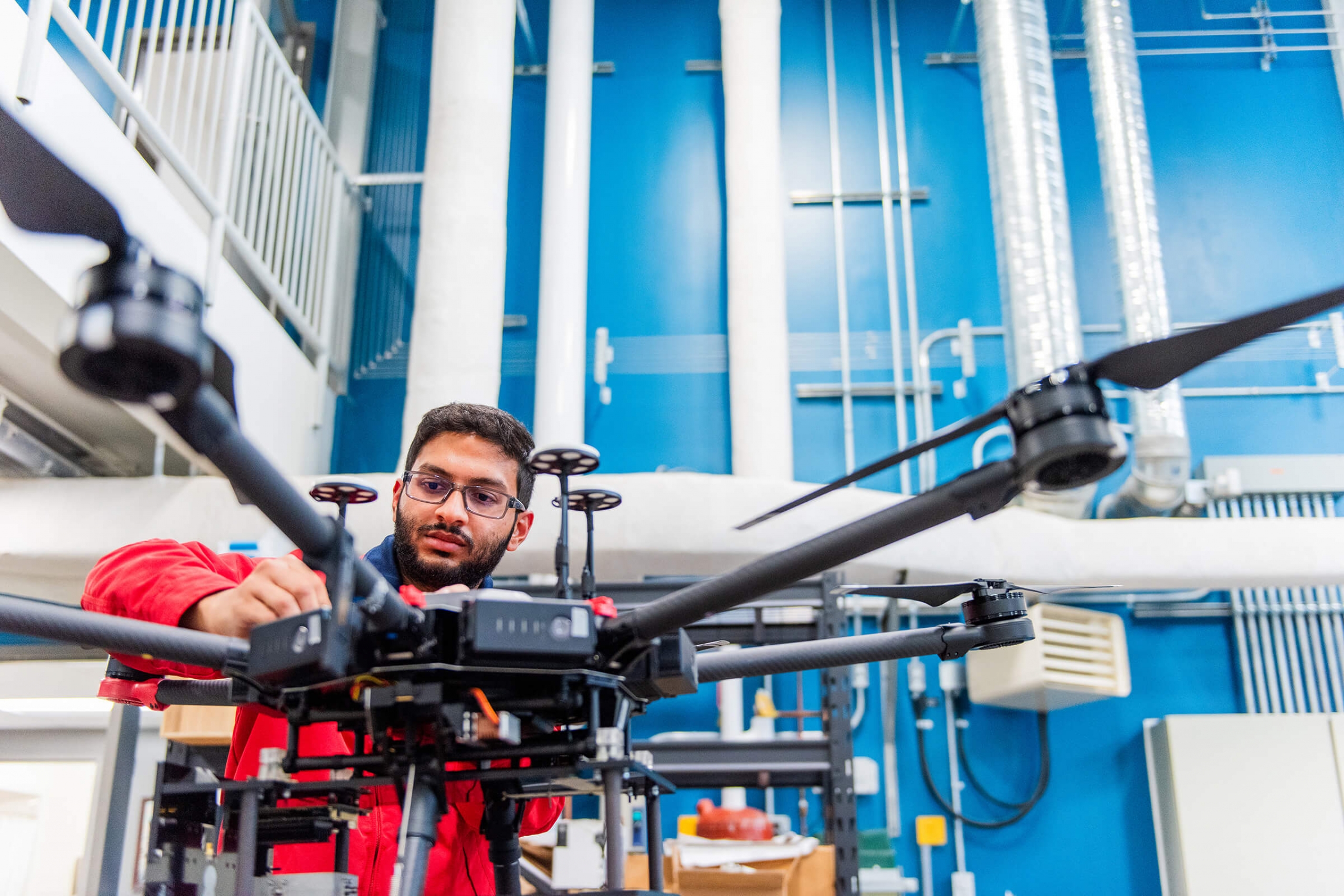 A man adjusts equipment in a garage