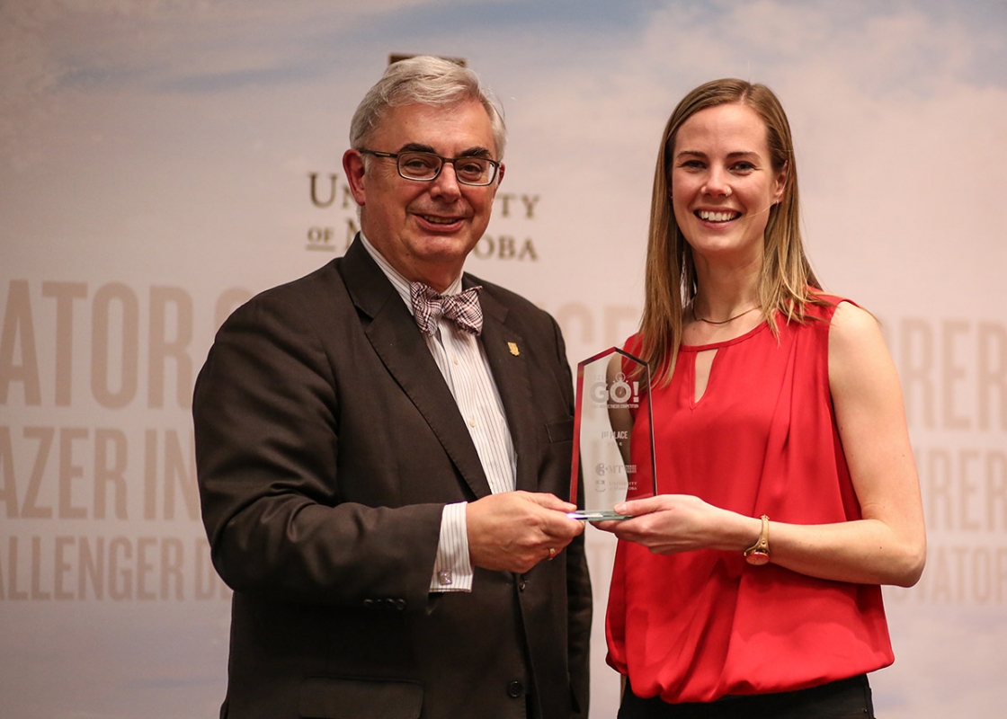 President and Vice-Chancellor David T. Barnard presents the First Place award to Karlee Dyck.  (Photo by Mike Latschislaw)