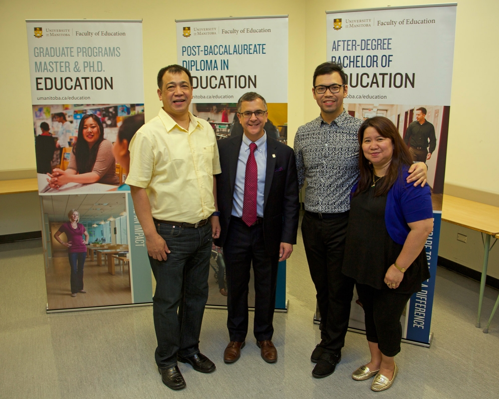 Dean of Education David Mandzuk poses with parents Ariel (far right) and Paz Arcega (far left) and son Julian, a graduate.