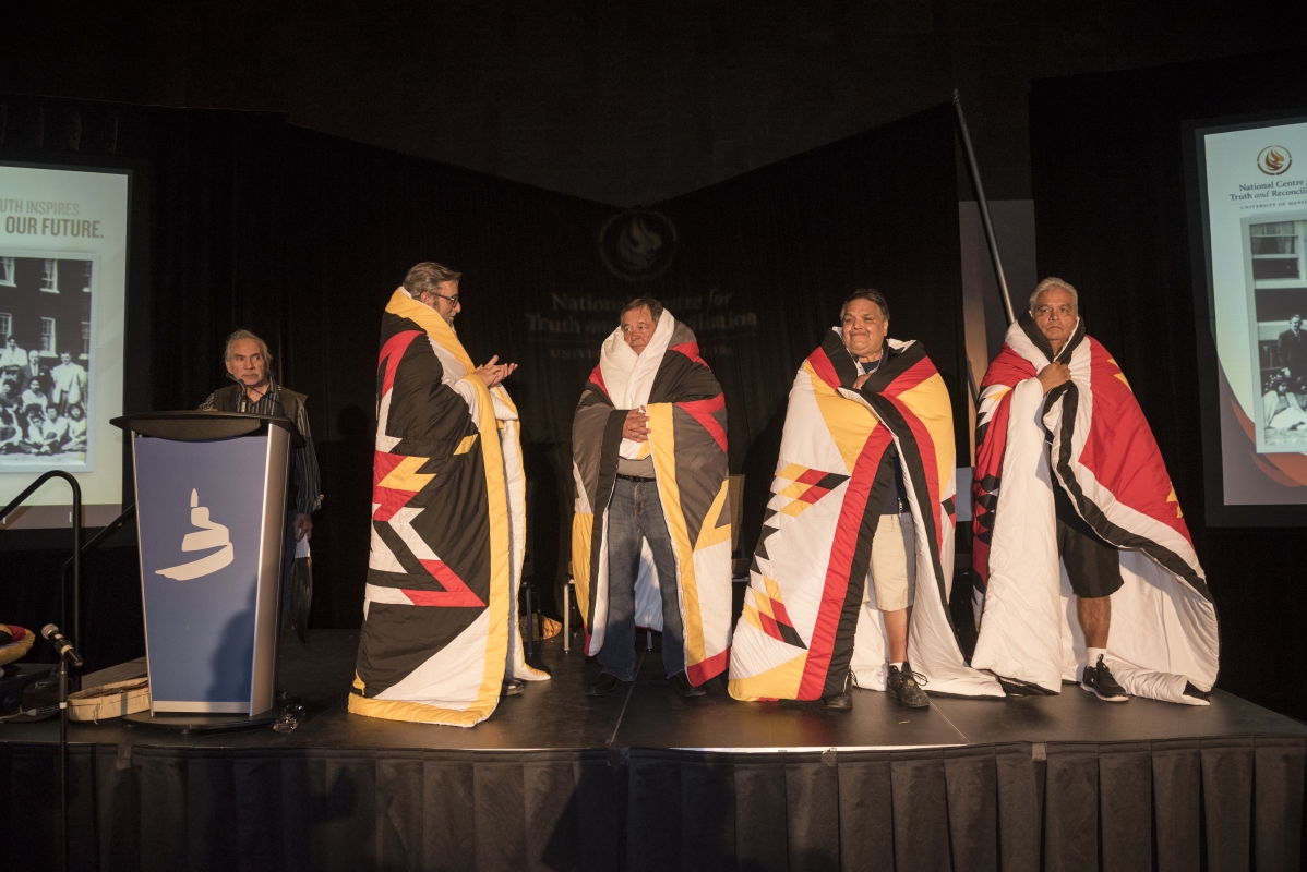 Port Alberni Residential School Survivors were honoured with a blanket ceremony. (l-r) Elder Henry Skywater, David Patterson, Gilbert Johnson, Mel Good, Maxkw-wun (White Deer).