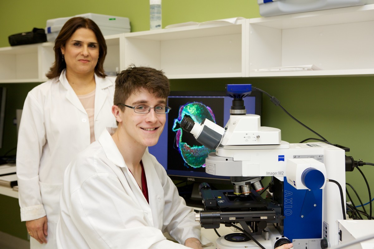 Science student Evan Proulx in the lab with Soheila Karima.