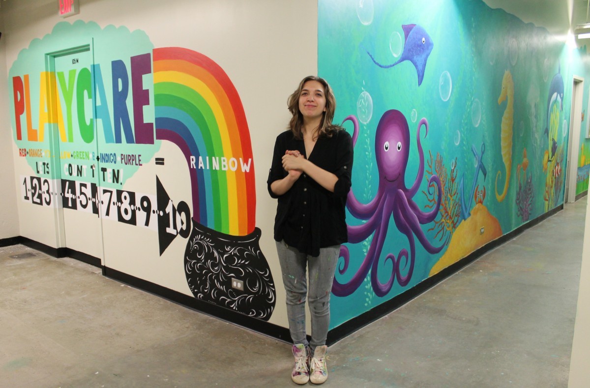 mural artist Anya Nikoulina with her mural