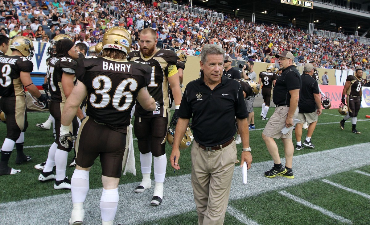 University of Manitoba Bisons head coach Brian Dobie walks the sideline during CIS football action against the University of Alberta Golden Bears on Fri., Aug. 30, 2013 at Investors Group Field.