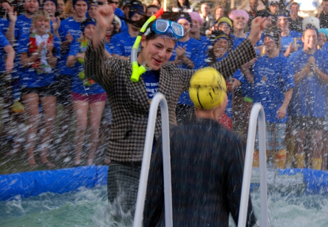 students jump into cold water for chairty