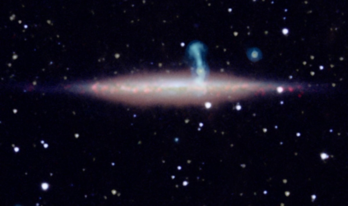 The edge-on spiral galaxy UGC 10288 (horizontal) appeared to be a single object in previous radio telescope observations. However, new, detailed radio data (cyan in this image) from the NRAO's VLA reveals that the large perpendicular (vertical) extension really is a distant background galaxy with radio jets. The foreground image of UGC 10288 includes data from optical, infrared and radio telescopes.