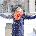 student joyful under snowfall