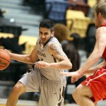 bison basketball player dribbles to the net