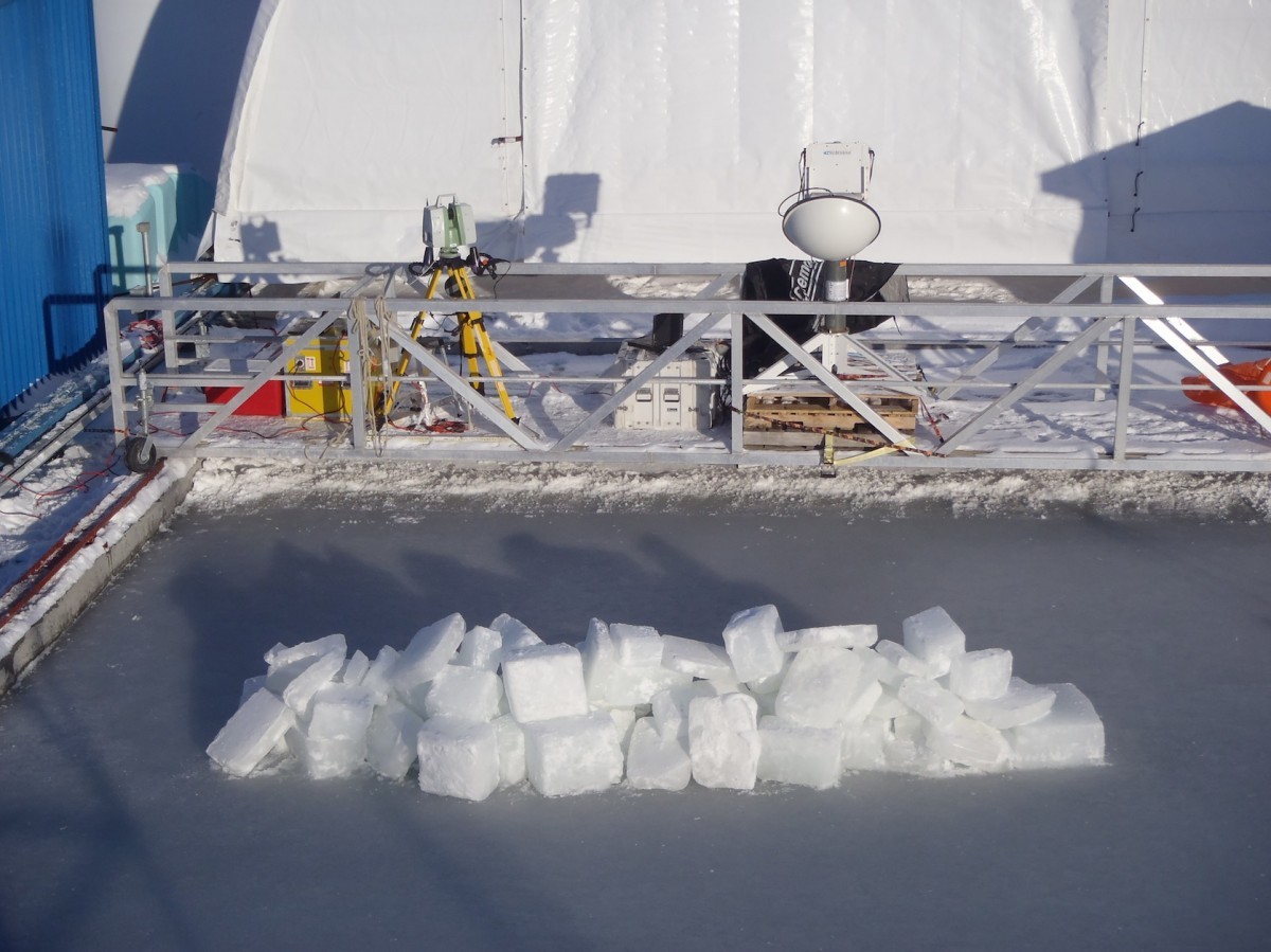 ice blocks sit atop sea ice created in an outdoor lab