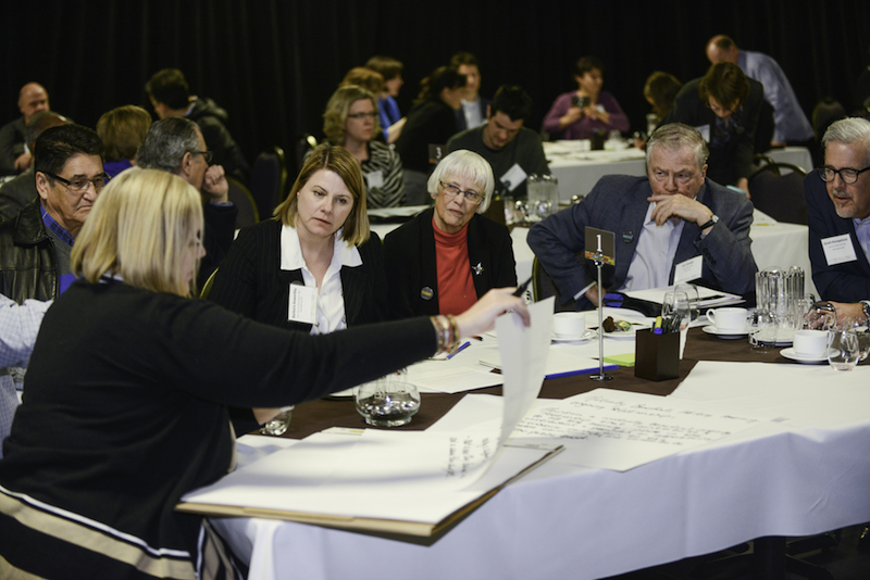 Alumni discuss things at a table