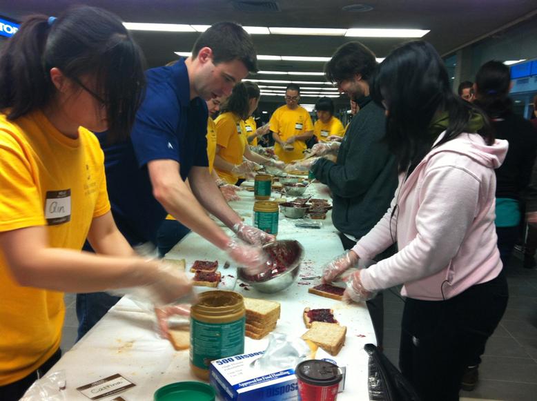students making peanut bu7tter and jam sandwiches for charity