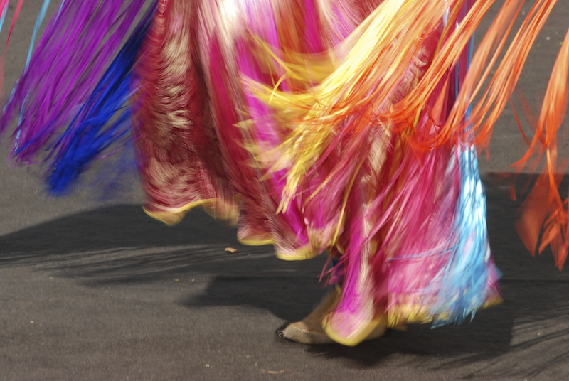 a blur of colours from a dancer at a pow wow