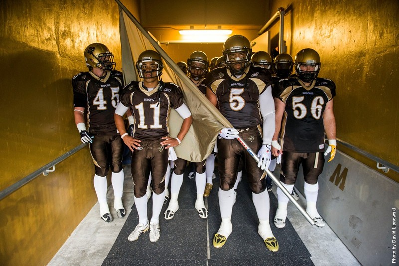 Bison Football players standing in a tunnel
