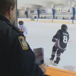police officer watching a hockey game