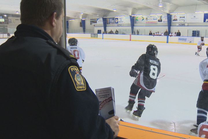 police officer watching a hockey game